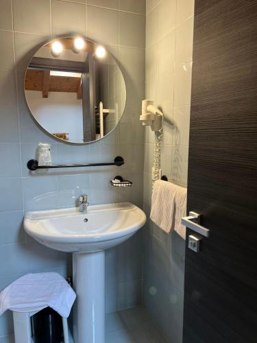 a bathroom with a sink and a mirror at Antico Albergo Stella d'Italia in Folgaria