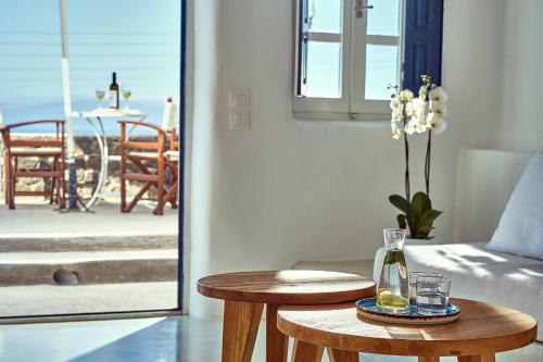 a living room with a table and a couch and a patio at Finikia Memories Hotel in Oia