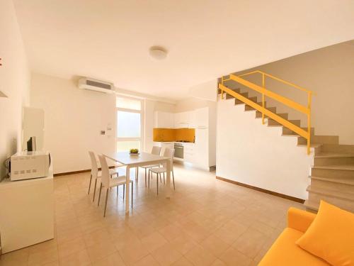 a kitchen and dining room with a table and a staircase at Le Naiadi Appartamenti in Bolsena