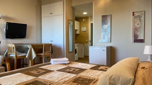 a room with a bed and a kitchen with a table at estudio con vista al mar 19 in Benalmádena