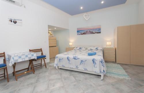 a bedroom with a bed and a table and chairs at Apartment Brajki in Omiš