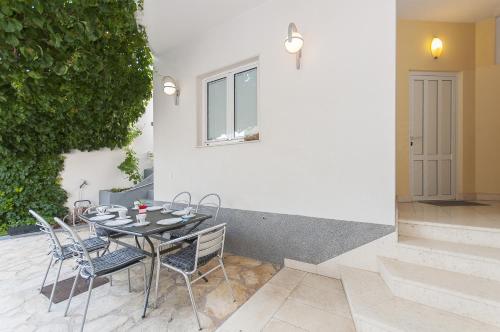 a table and chairs sitting on a patio at Apartment Brajki in Omiš