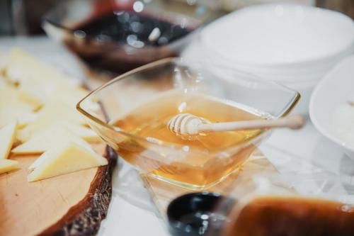 a glass of tea and cheese on a table at Lot Boutique Hotel by Hotels and Preference in Tirana