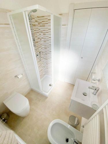 a bathroom with a toilet and a sink and a mirror at Le Naiadi Appartamenti in Bolsena