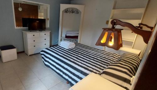 Ένα ή περισσότερα κρεβάτια σε δωμάτιο στο Merlo 1