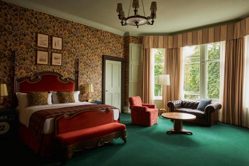 a bedroom with a bed and a chair and a table at Marine North Berwick in North Berwick