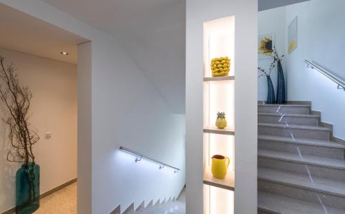a staircase in a house with a stair shelf at Haus Wiesenstein in Lana