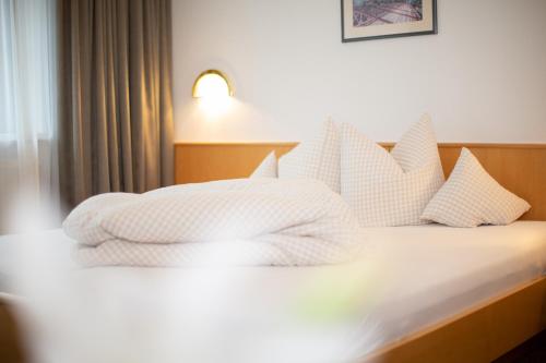 a bedroom with a bed with white pillows at Tonis Ferienheim in Sölden