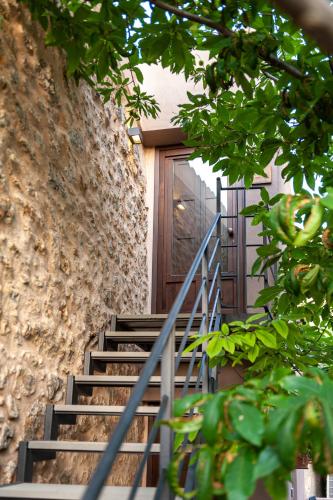 a set of stairs leading to a wooden door at Gratteri Resort in Gratteri