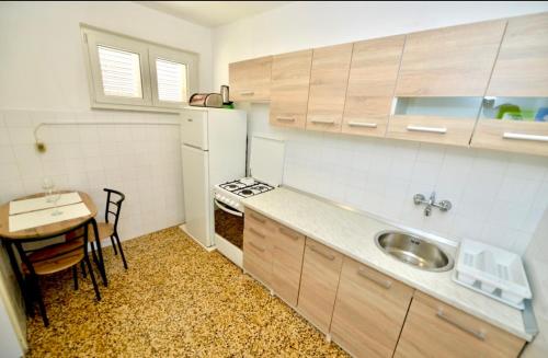 a small kitchen with a table and a sink at Apartment Niksa in Novigrad Dalmatia