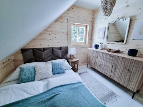 a bedroom with a large bed and a mirror at Koniakowo - dom Forest in Koniaków