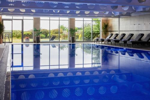 a large swimming pool with chairs in a building at Marine North Berwick in North Berwick