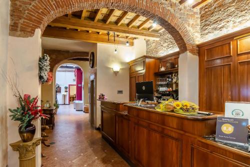 a kitchen with an archway and a counter with food at Hotel Porta Faenza in Florence