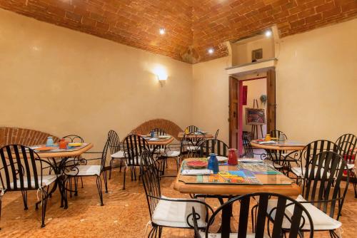 a room with tables and chairs in a restaurant at Hotel Porta Faenza in Florence