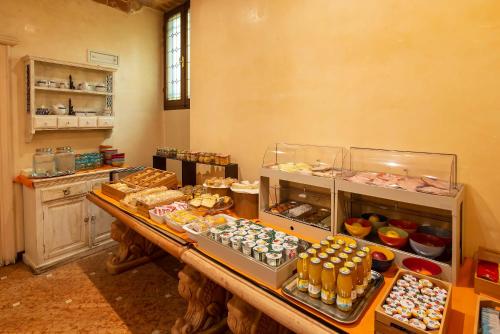 a bakery with a table filled with different types of pastries at Hotel Porta Faenza in Florence