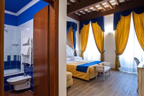 a bedroom with a bed and a tub and a sink at Hotel Porta Faenza in Florence