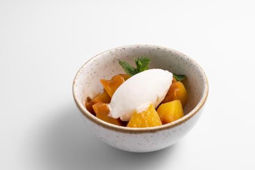 a bowl of food with oranges and sour cream at Áurea Palacio de Correos by Eurostars Hotel Company in Logroño