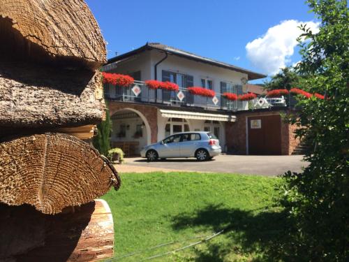 a white car parked in front of a house at Agritur Casamela in Taio