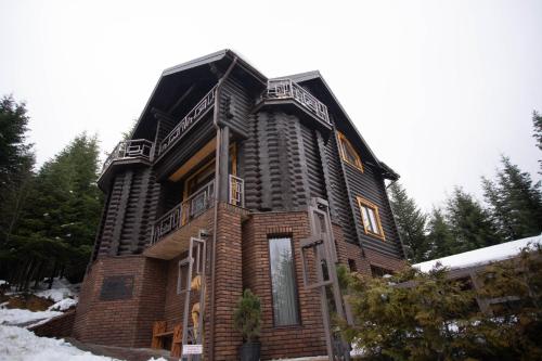 a house is shown in the snow at Green Zone in Migovo