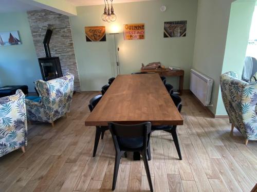 a dining room with a wooden table and chairs at Atlantic Retreat Lodge in Kinvara