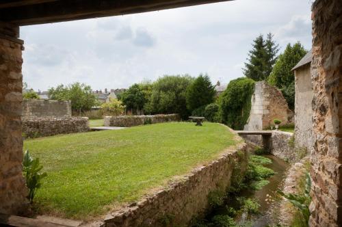 a view of the garden from the ruins of a building at Gîte des Grands Moulins de Baugé in Baugé-en-Anjou