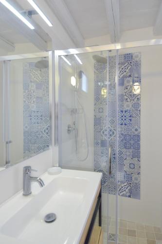a bathroom with a shower and a white sink at A Casa di Elena in Polignano a Mare