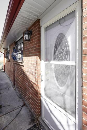 a front door of a brick house with a window at Private Room near Airport in Mississauga