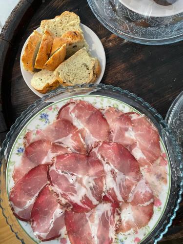 a table topped with a plate of food with bread at La Selce Farmhouse in Bagnaria Arsa