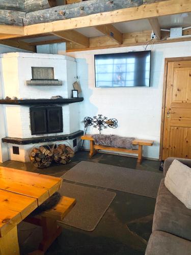 a living room with a fireplace and a couch at Liirakka Levi in Levi