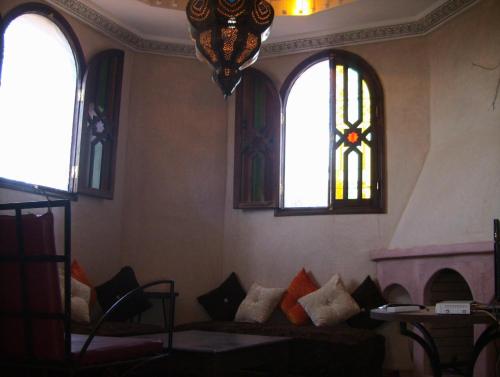 a living room with a couch and stained glass windows at Atlas Resorts in Aït Ourir