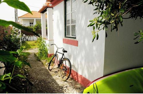 a bike parked in front of a house at GetWet SurfCamp II in Costa da Caparica