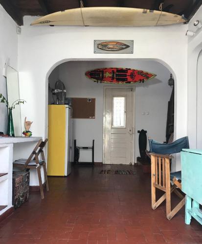 a room with a surfboard hanging on the wall at GetWet SurfCamp II in Costa da Caparica