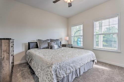 a bedroom with a bed and two windows at Idyllic Pensacola Home with Yard and Fire Pit! in Pensacola