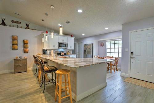 a kitchen with a large island with bar stools at Updated Tavares Retreat Less Than 1 Mile to Boat Ramp in Tavares