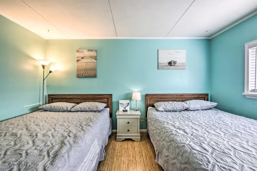 two beds in a room with blue walls at Bright Condo Half-Block to Cape May Beach! in Cape May