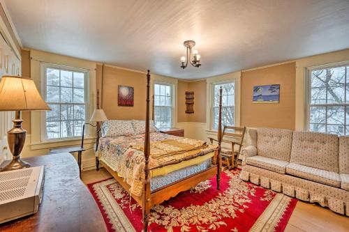 a bedroom with a bed and a couch at Vintage Farmhouse Near Sunday River Ski Slopes! in Rumford