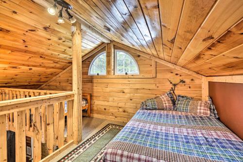 a bedroom of a log cabin with a bed in it at Pet-Friendly Brantingham Cabin by ATV Trails in Glenfield