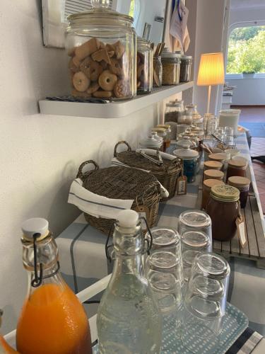 a counter with many bottles and glasses on it at Valle dei Mulini B&B in Marciana