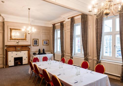 a meeting room with a table and chairs in it at Dukes Head Hotel Kings Lynn in Kings Lynn