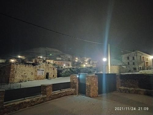 a view of a city at night with a street light at Puerta del Maestrazgo in Monteagudo del Castillo