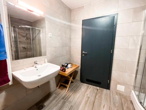a bathroom with a sink and a mirror at Sunshine Apartments Golte COMFORT in Mozirje