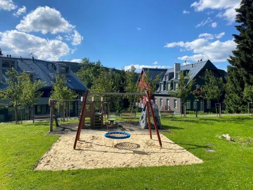 a playground in a park with at Útulné studio s balkónem in Harrachov