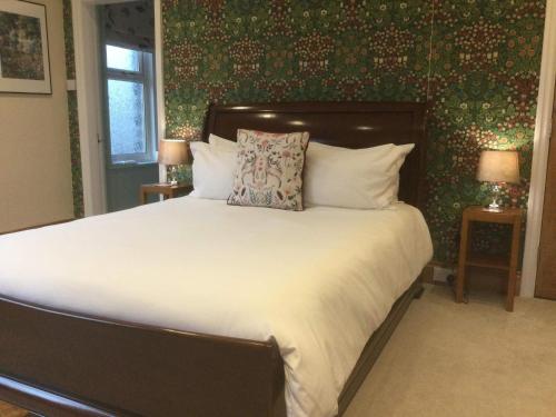 a bedroom with a large white bed with two lamps at The Coal Merchant's House in Whitby