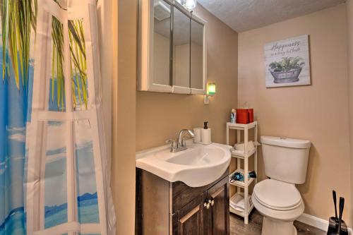 a bathroom with a sink and a toilet and a shower at Cozy Third-Story Apartment in Dtwn Brockton! in Brockton