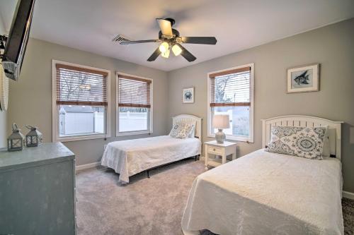 a bedroom with two beds and a ceiling fan at Charming Somers Point House with Private Pool! in Somers Point