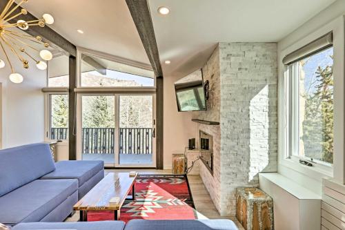 a living room with a blue couch and a fireplace at Snowmass Condo Great Proximity to Chair Lift in Snowmass Village