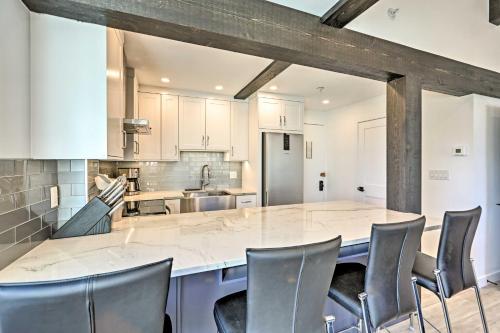 an open kitchen with a large island with chairs at Snowmass Condo Great Proximity to Chair Lift in Snowmass Village