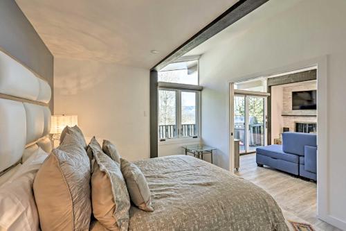 a bedroom with a large bed and a blue couch at Snowmass Condo Great Proximity to Chair Lift in Snowmass Village