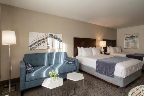 a hotel room with a bed and a couch at Oxford Suites Portland - Jantzen Beach in Portland