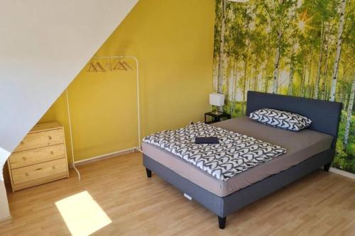 a bedroom with a bed and a dresser and a staircase at L8 Street - Pforzheim Nordstadt in Pforzheim